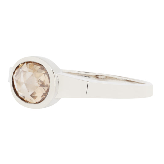 White Gold ring with a round, brown gemstone on a white background