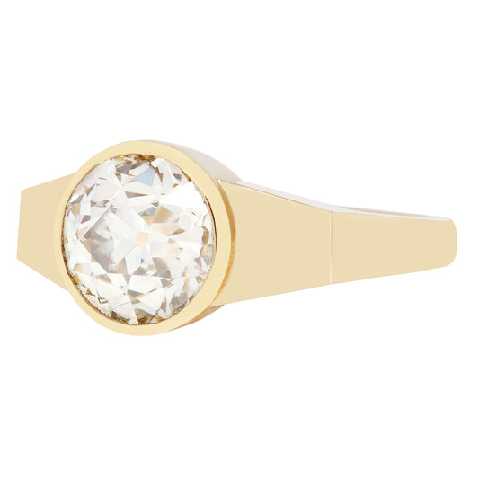 Gold ring with a large diamond on a white background