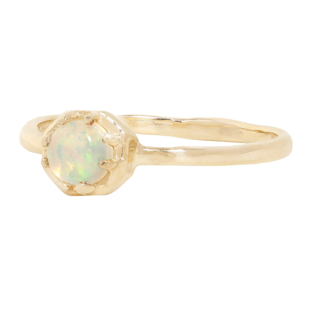 A gold ring featuring a round iridescent opal gemstone in a textured prong octagon setting, shown against a plain white background.