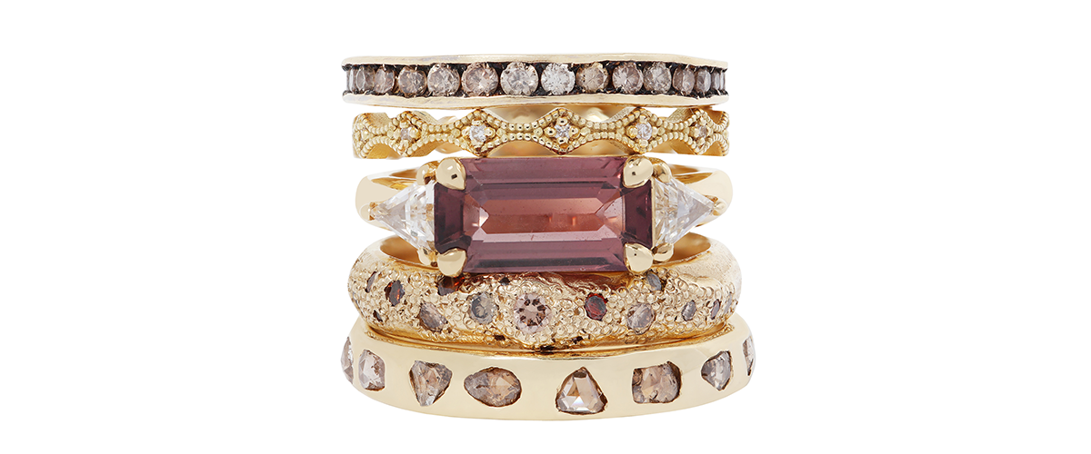 5 gold rings with multicolored sapphires and diamonds on white  background