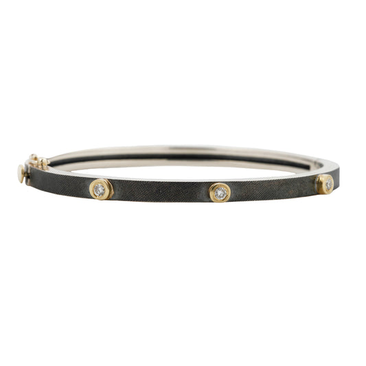 Rene Escobar - Silver and gold bracelet with diamonds on a white background