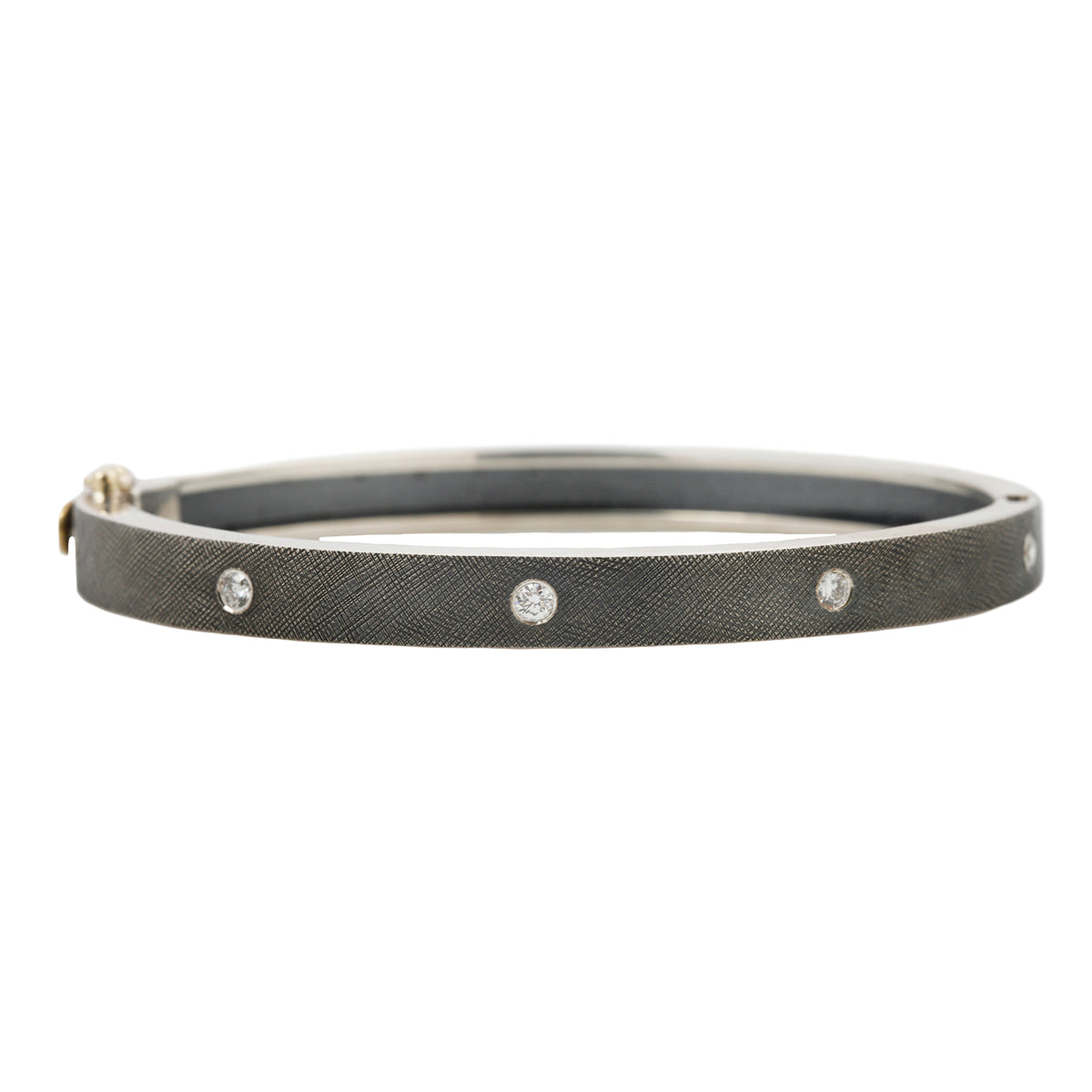 Rene Escobar - Silver bangle with diamonds on a white background