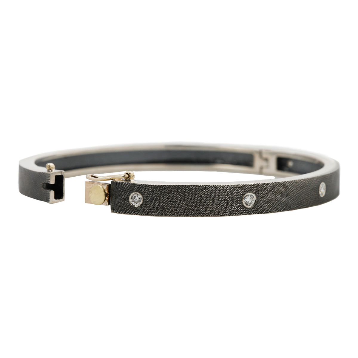 Rene Escobar - Silver bangle with diamonds on a white background