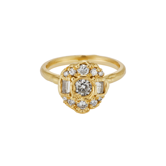 A yellow gold ring featuring a central round diamond surrounded by a cluster of smaller diamonds, including baguette-cut diamonds on the sides, set against a plain white background.