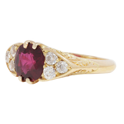Antique Gold ring with a red ruby and diamond accents on a white background