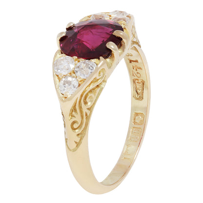 Antique Gold ring with a red ruby and diamond accents on a white background