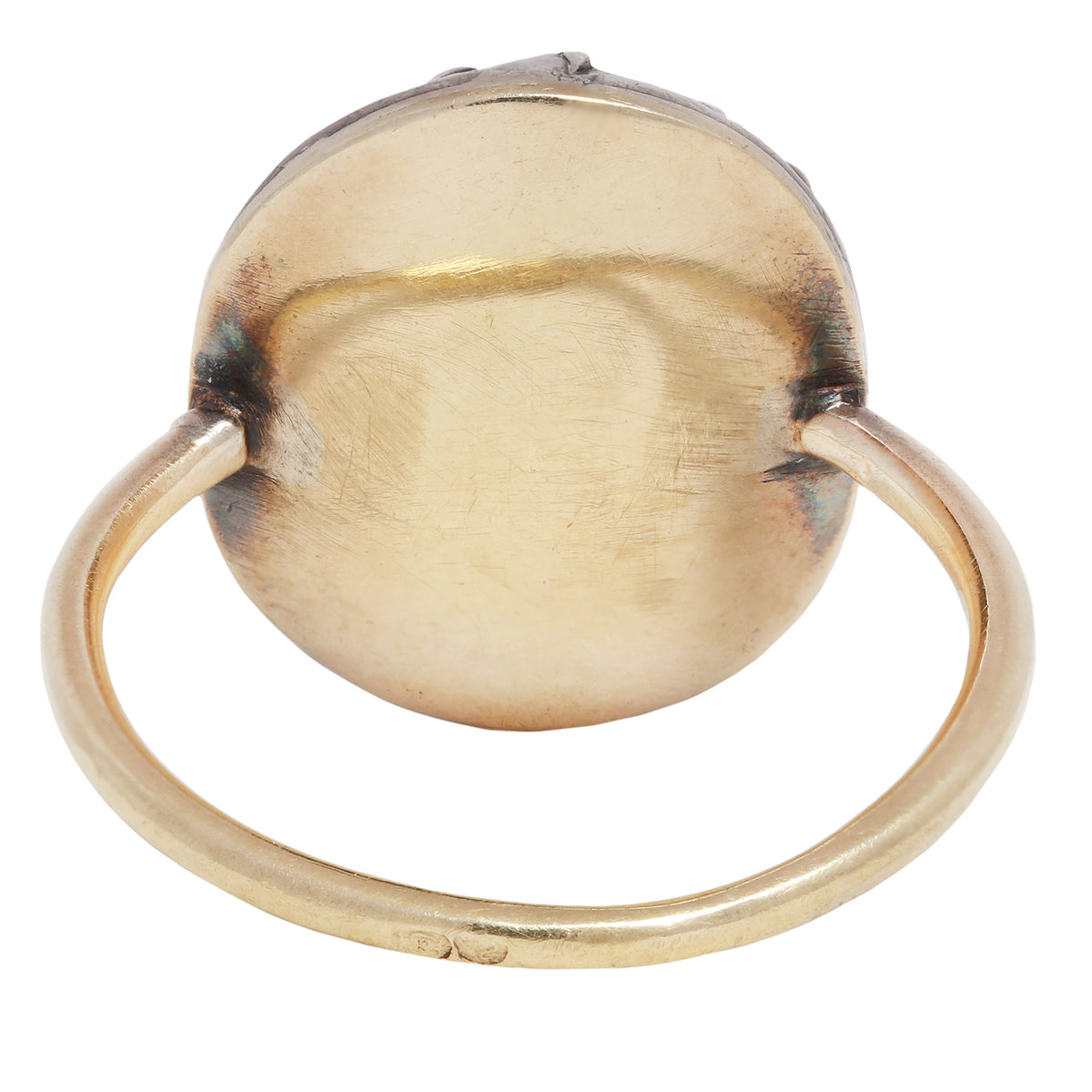 Antique ring with central gemstone and smaller green stones on a white background