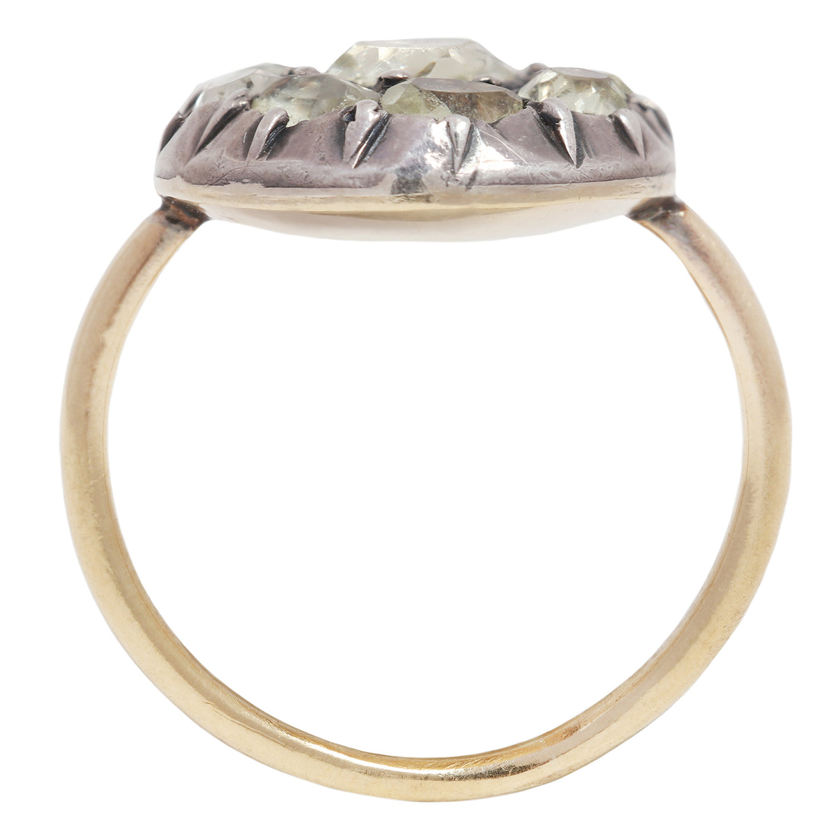 Antique ring with central gemstone and smaller green stones on a white background