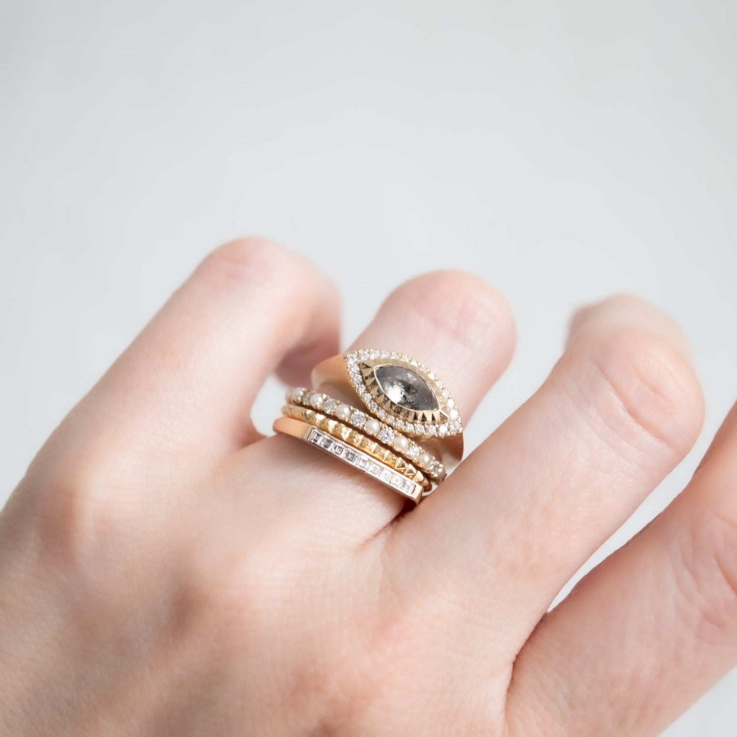 a stack of four rings on a hand