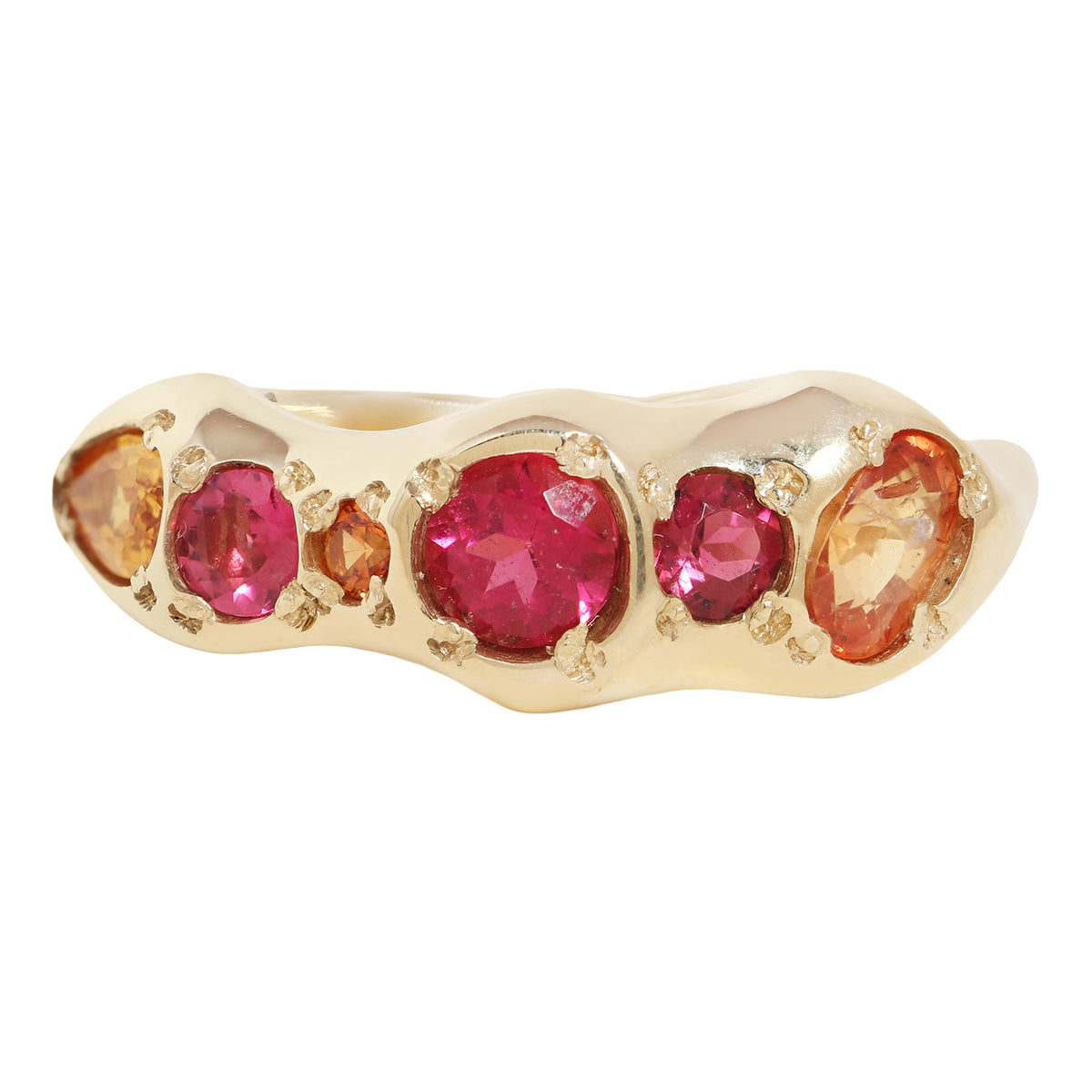 A gold ring featuring a row of round and oval pink gemstones and smaller orange gemstones, set against a plain white background.