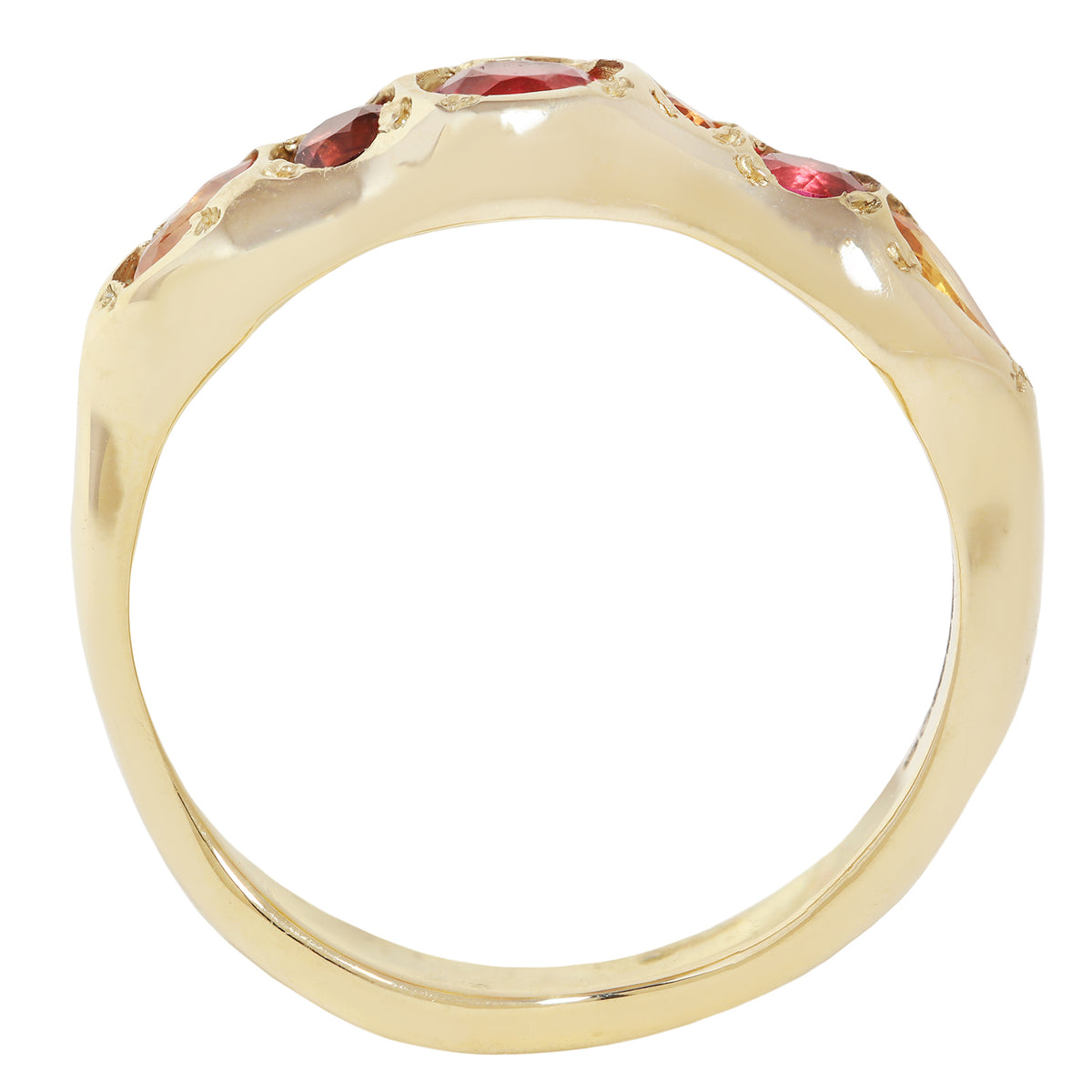 A yellow gold ring with a wide, polished band featuring a row of small red gemstones set along the top, shown against a plain white background.