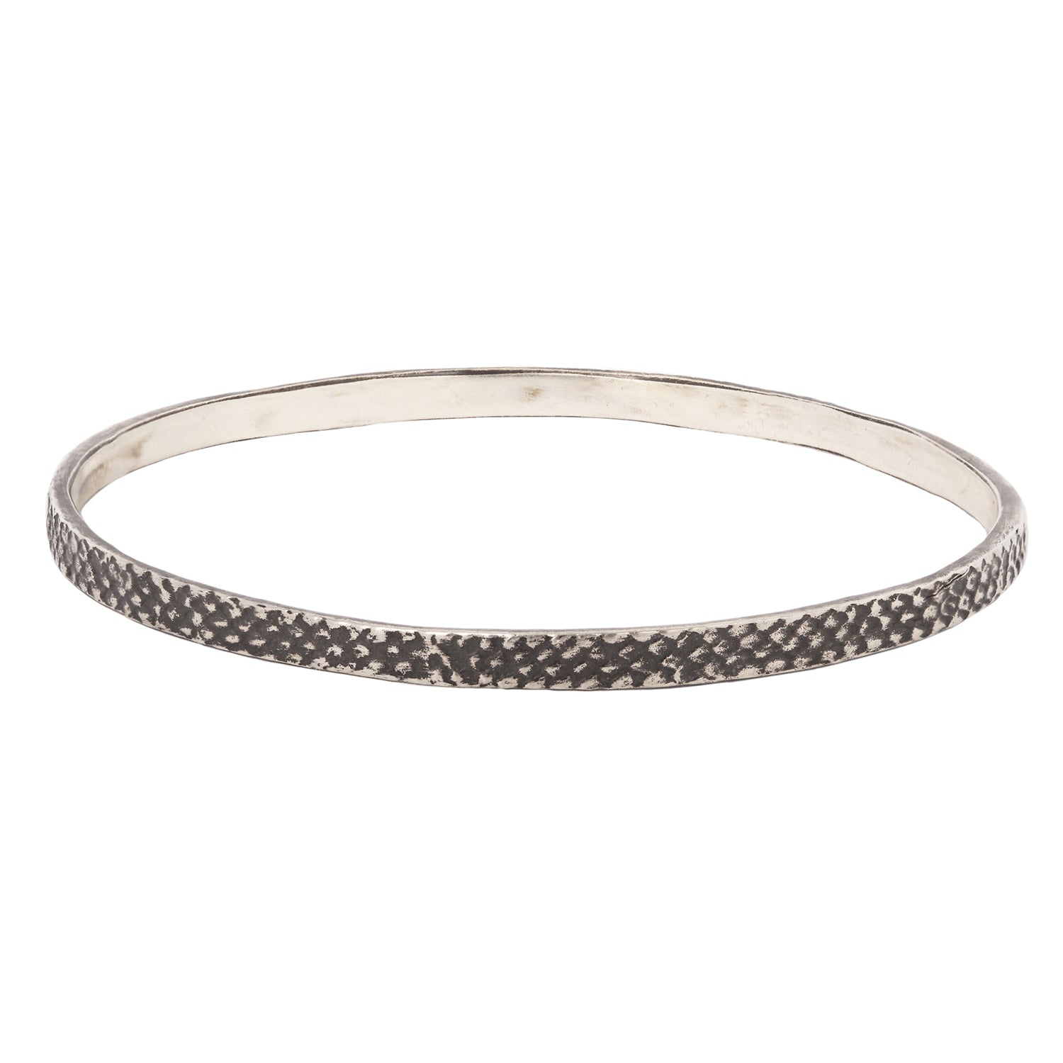 silver bangle with textured, oxidized finish against a white backdrop - Lauren Wolf Jewelry | ESQUELETO
