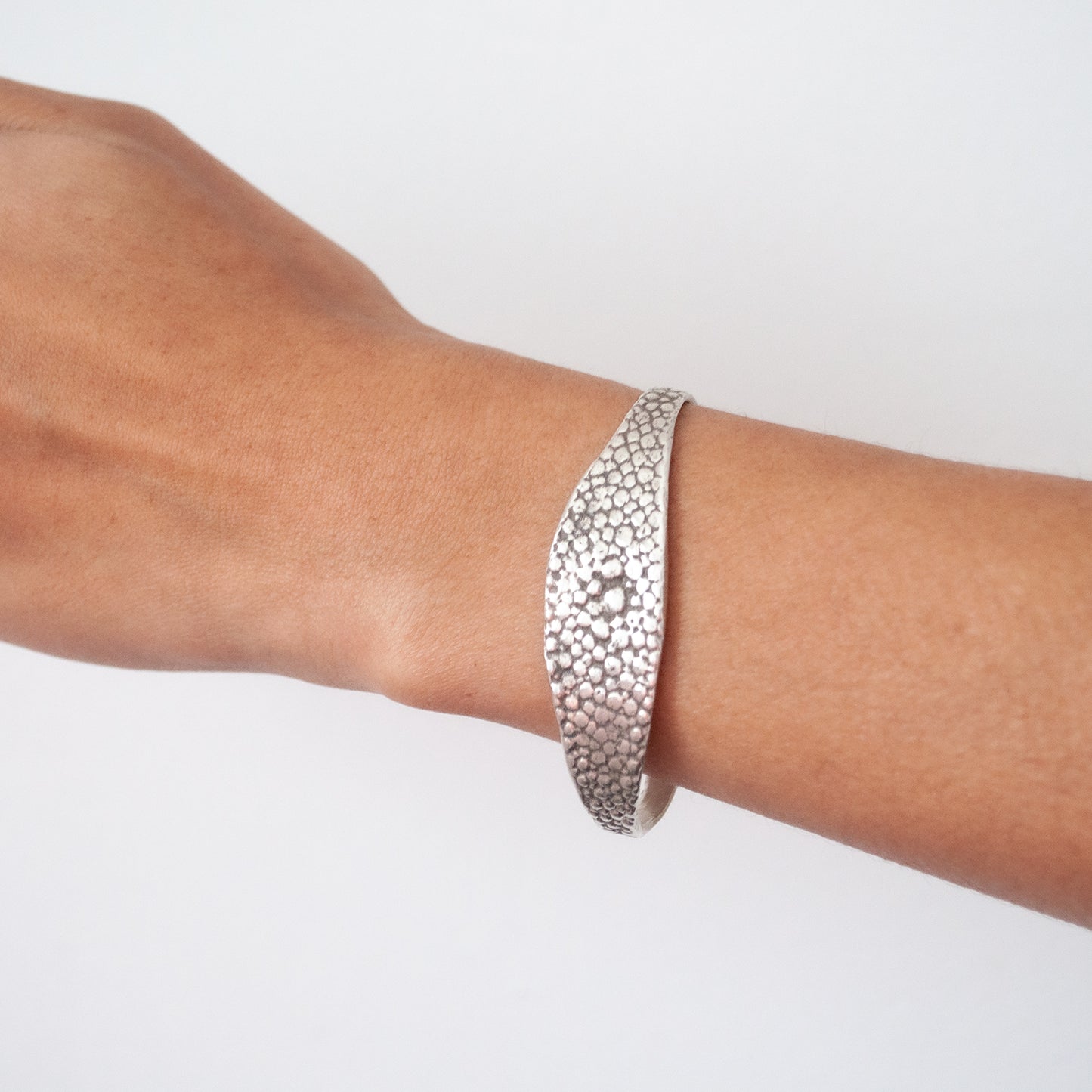 textured oxidized silver bangle worn on the wrist - Lauren Wolf Jewelry | ESQUELETO
