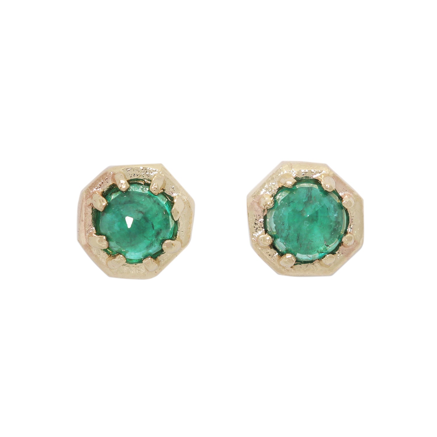 Pair of gold earrings with green gemstones on a white background