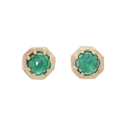 Pair of gold earrings with green gemstones on a white background