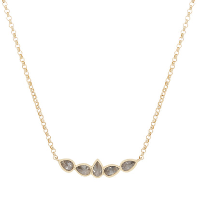 Gold necklace with five teardrop-shaped stones on a white background