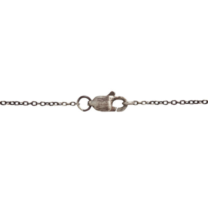 Closure detail image on white background of  the emerald pendant set in gold on an oxidized silver chain