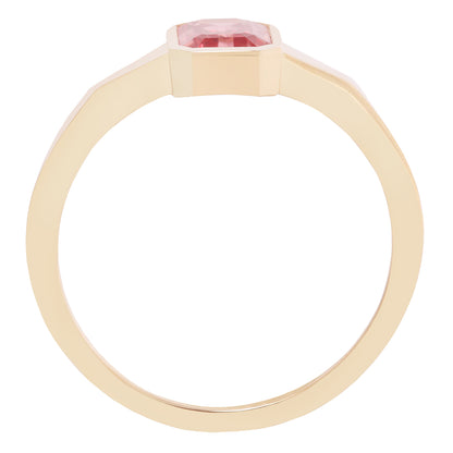 Gold ring with a pink gemstone on a white background