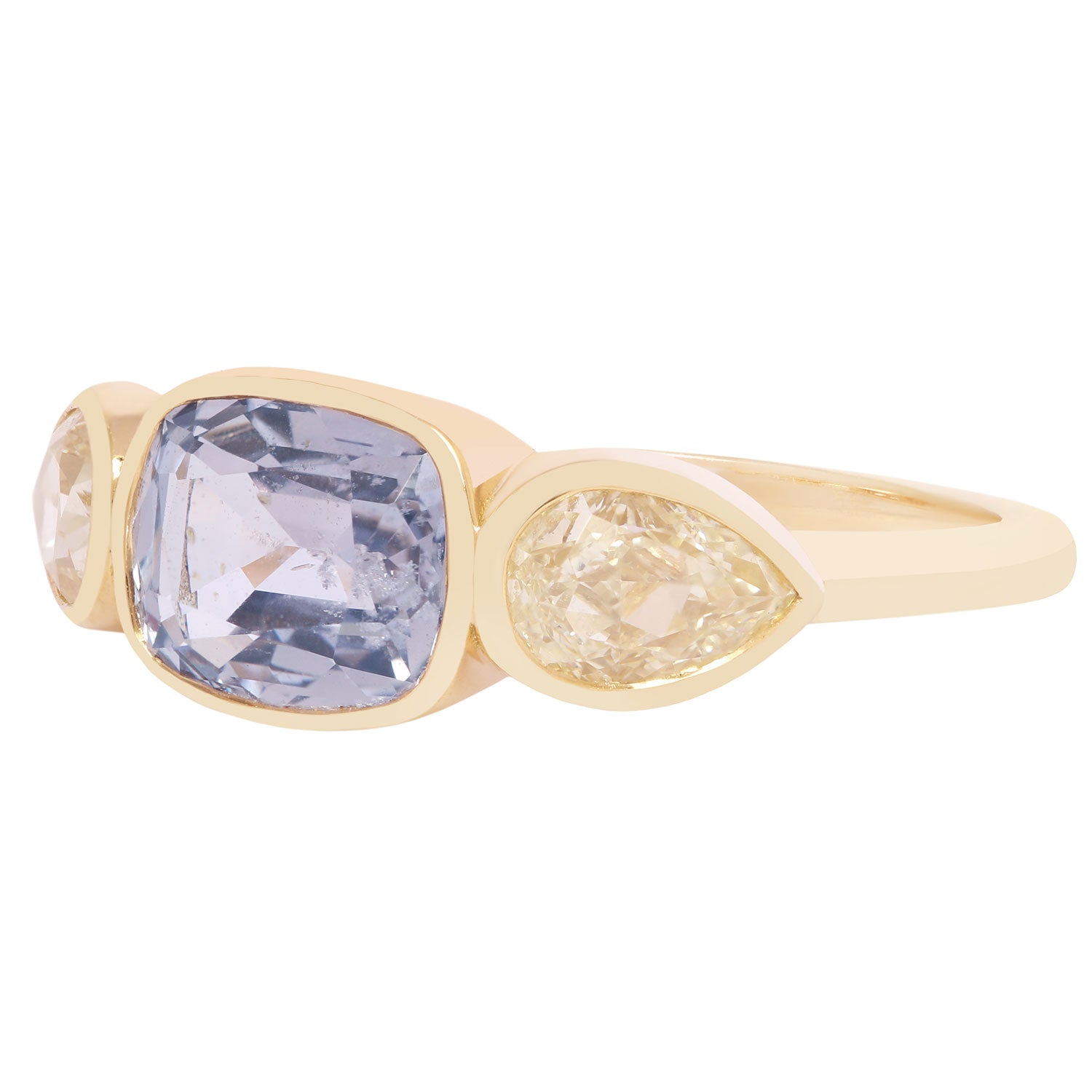 Lauren Wolf - Gold ring with a large purple gemstone and smaller yellow gemstone on a white background