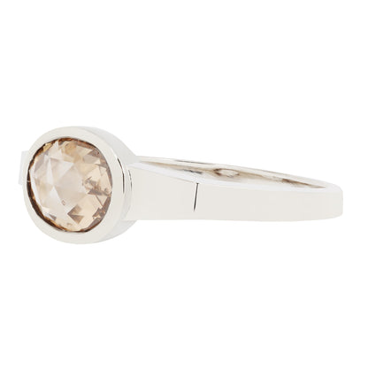 White Gold ring with a round, brown gemstone on a white background