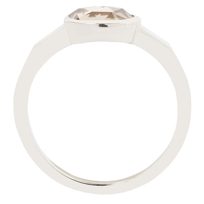 White gold ring with a clear gemstone on a white background