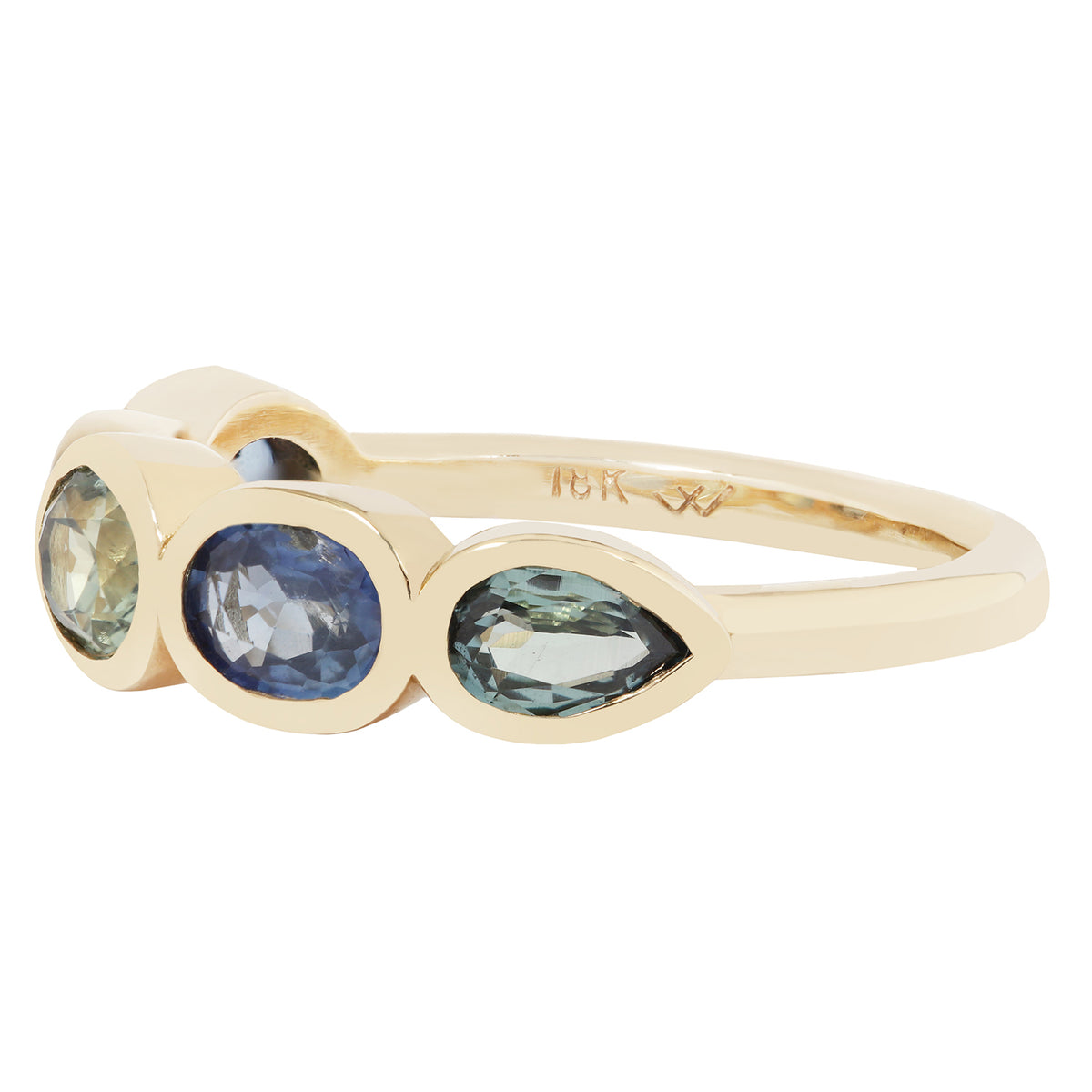 Gold ring with three oval gemstones on a white background
