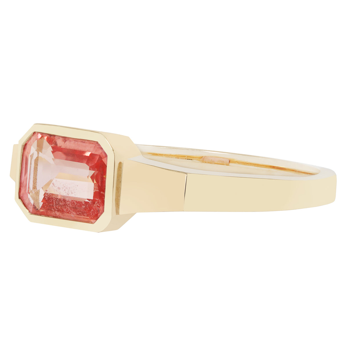 Gold ring with a pink gemstone on a white background