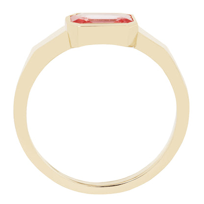 Gold ring with a pink gemstone on a white background