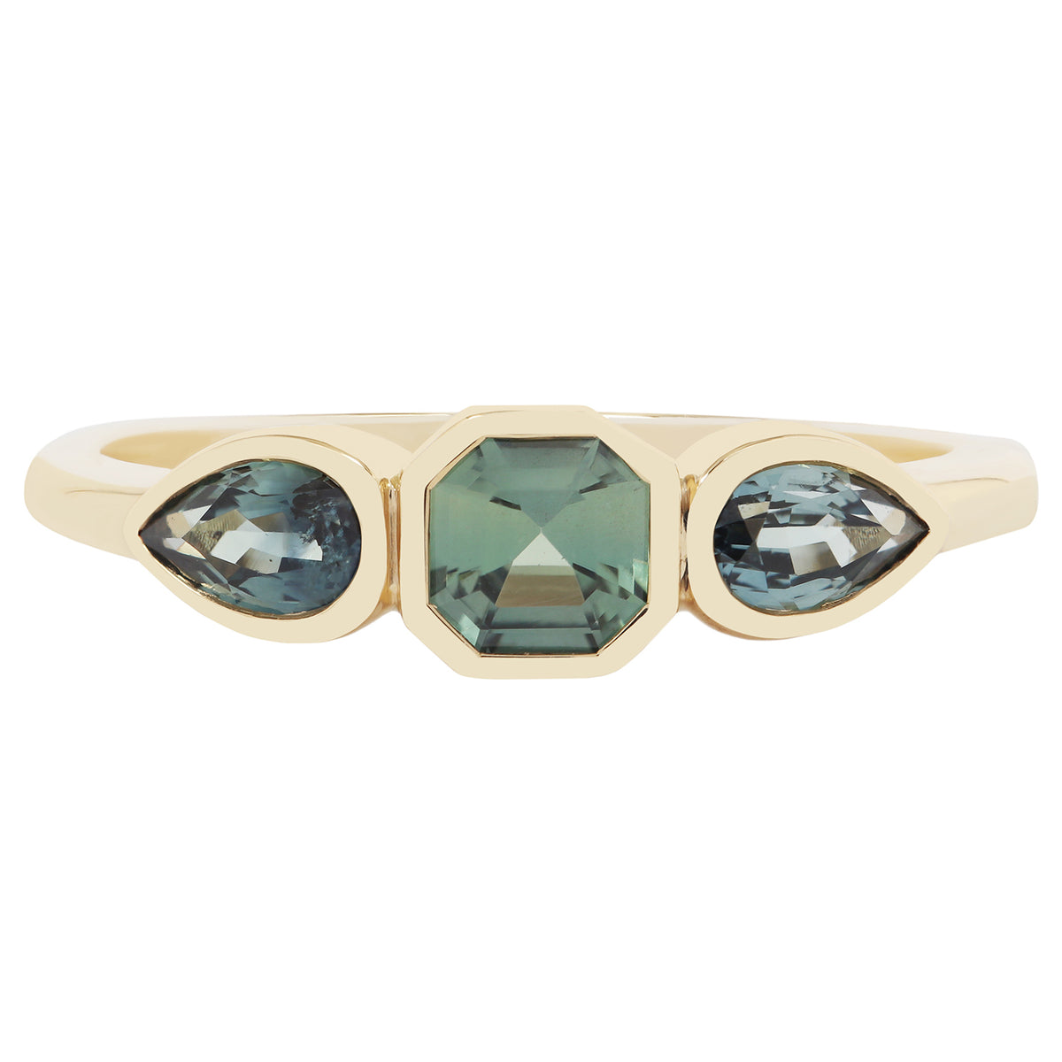 Gold ring with green gemstones on a white background