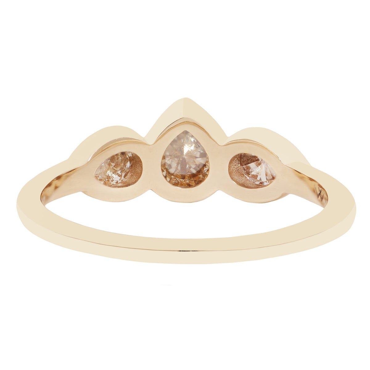 Three pear shape diamond ring in yellow gold on a white background