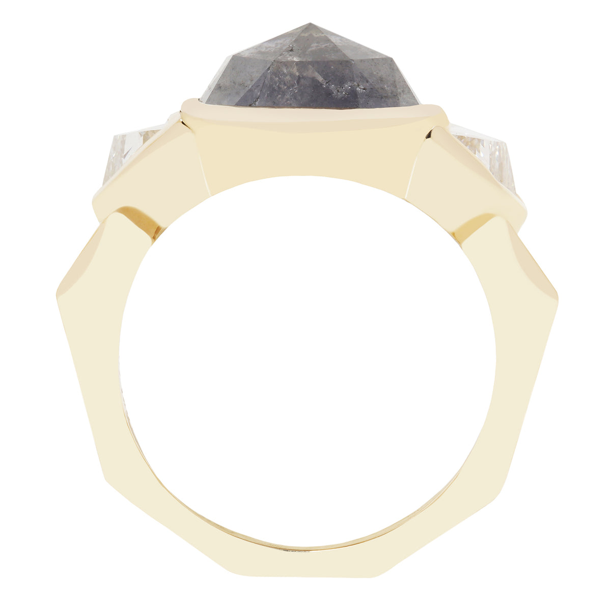 A geometric octagonal ring featuring a faceted dark gray diamond stone in a gold setting, flanked by two clear round-cut stones on a plain white background.