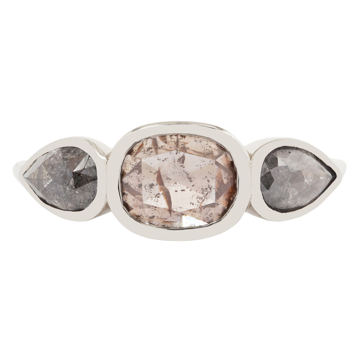 White gold ring with three pear-shaped gemstones on a white background