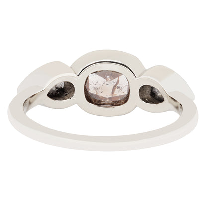 White gold ring with three round gemstones on a white background
