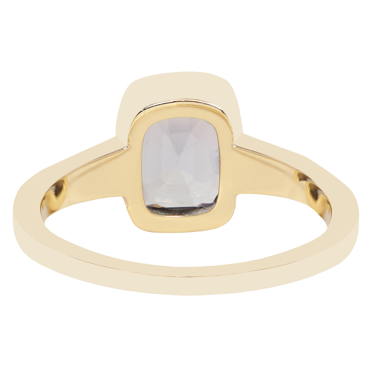 Bezel set solitaire yellow gold ring with a dark blue spinel rectangular stone on white background. 