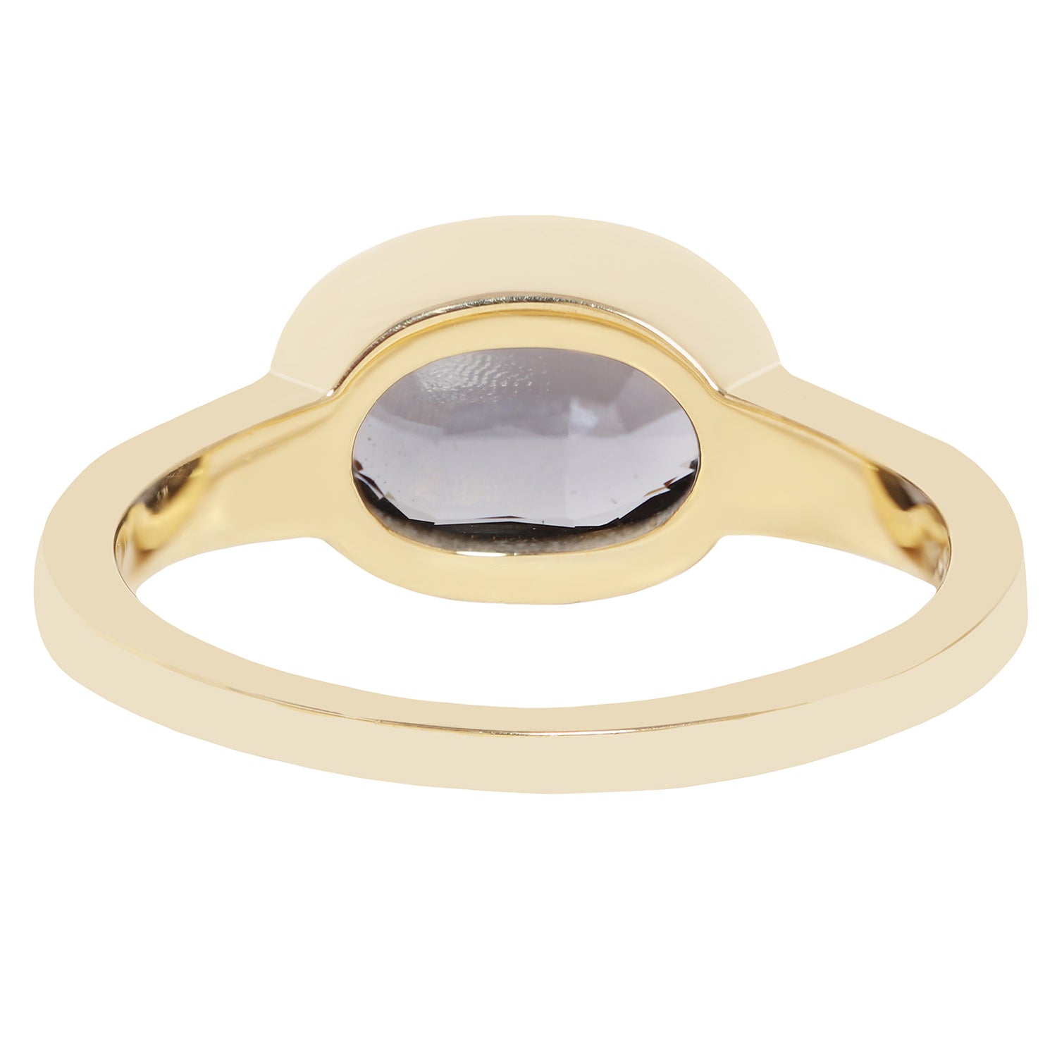 A gold signet-style ring with a smooth, polished band and a semi-circular bezel holding a dark gray oval gemstone, shown against a plain white background.
