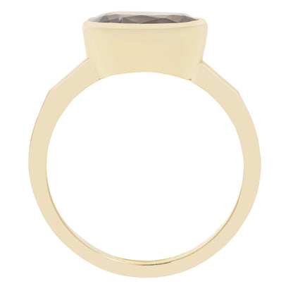 A minimalist gold ring with a wide, polished band and a large, smooth, rounded rectangular bezel holding a dark gray faceted gemstone, shown against a solid white background.