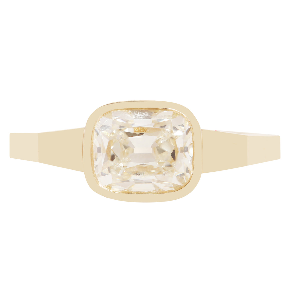 A gold ring with a square bezel-set clear diamond 