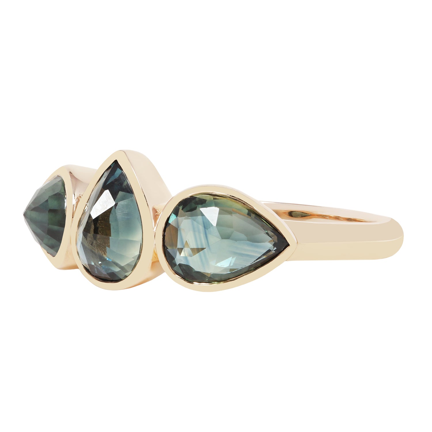 A gold ring featuring three teardrop-shaped light blue-green gemstones in a row, set against a plain white background.