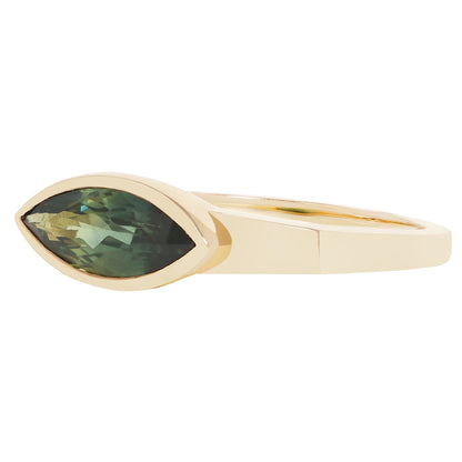 A gold ring featuring a marquise-cut green gemstone in a bezel setting, shown against a plain white background.