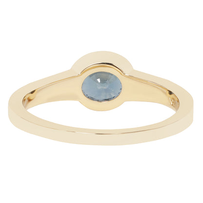 A gold ring with a smooth, polished band and a small, round, light blue gemstone set in a semi-circular crown-like setting, shown against a plain white background.