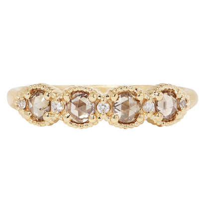 Gold ring with rose-cut diamonds on a white background
