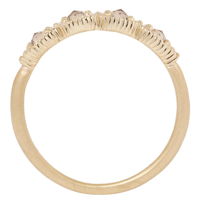 Gold ring with diamond stones on a white background