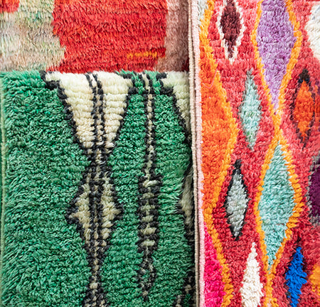 Close-up of colorful textured wool rugs with geometric patterns