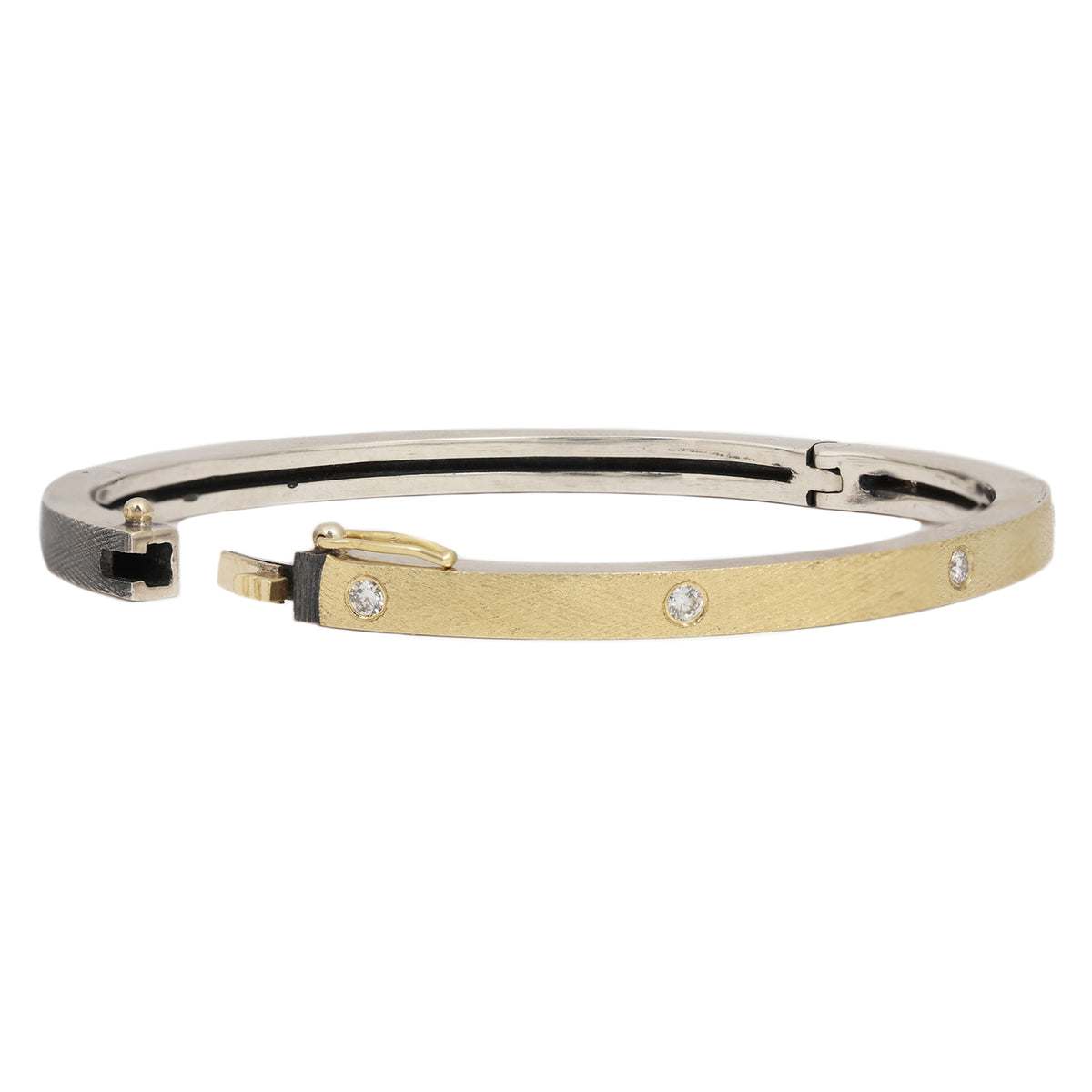 Rene Escobar - Gold and silver bangle with embedded stones on a white background
