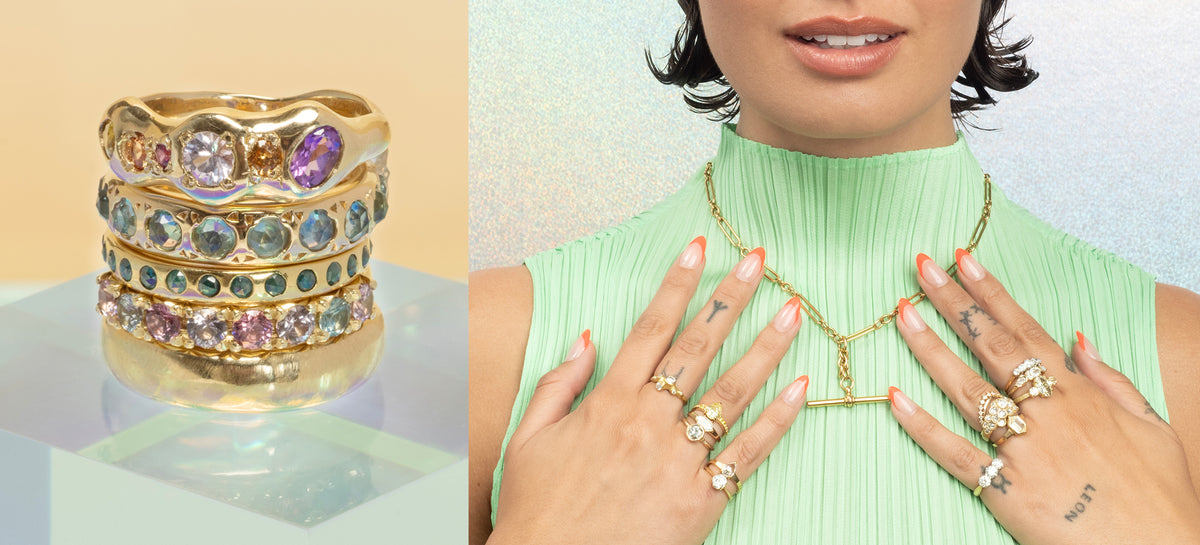 Gold rings with colorful stones on a reflective surface, and a person wearing gold jewelry including a necklace and rings.