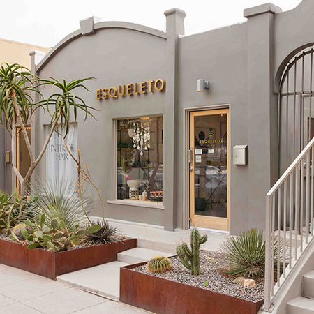 Storefront of ESQUELETO Los Angeles exterior shot with plants in front