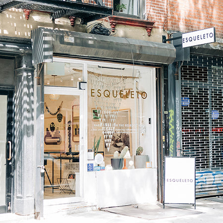 Storefront of ESQUELETO New York with glass door and interior display.