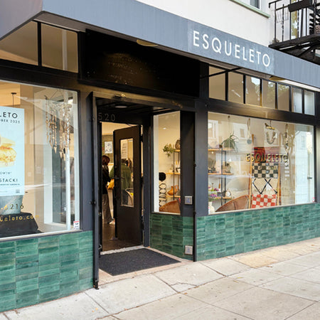 Storefront of ESQUELETO Oakland with glass door and interior display.