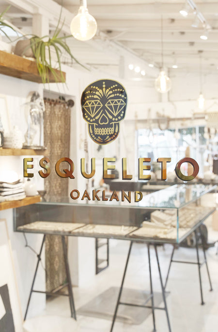 Shop with 'ESQUELETO Oakland' sign on a glass.