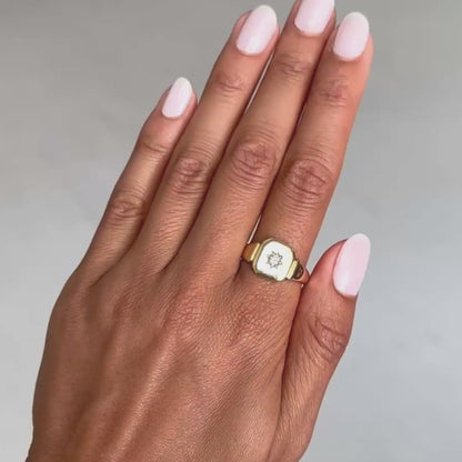 Antique - Hand wearing a gold ring with a diamond on a gray background